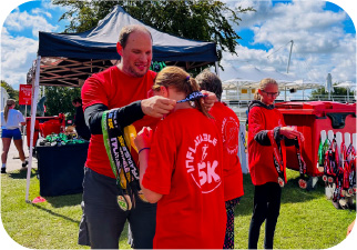 Inflatable 5k - Volunteers handing out medals